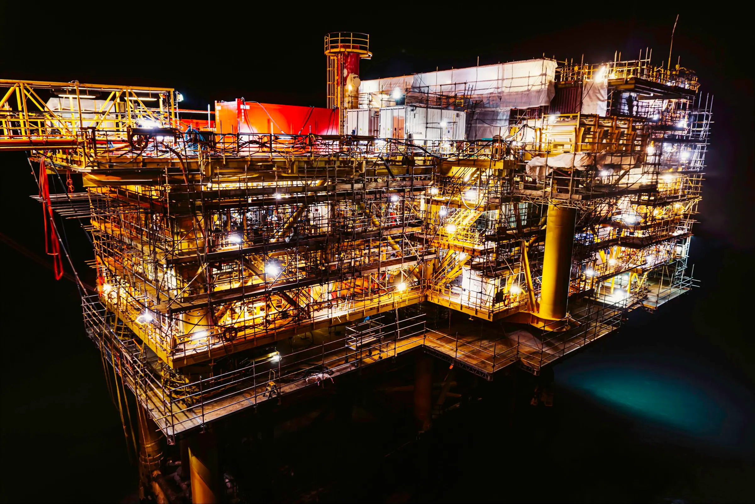Offshore production platform lit up at night
