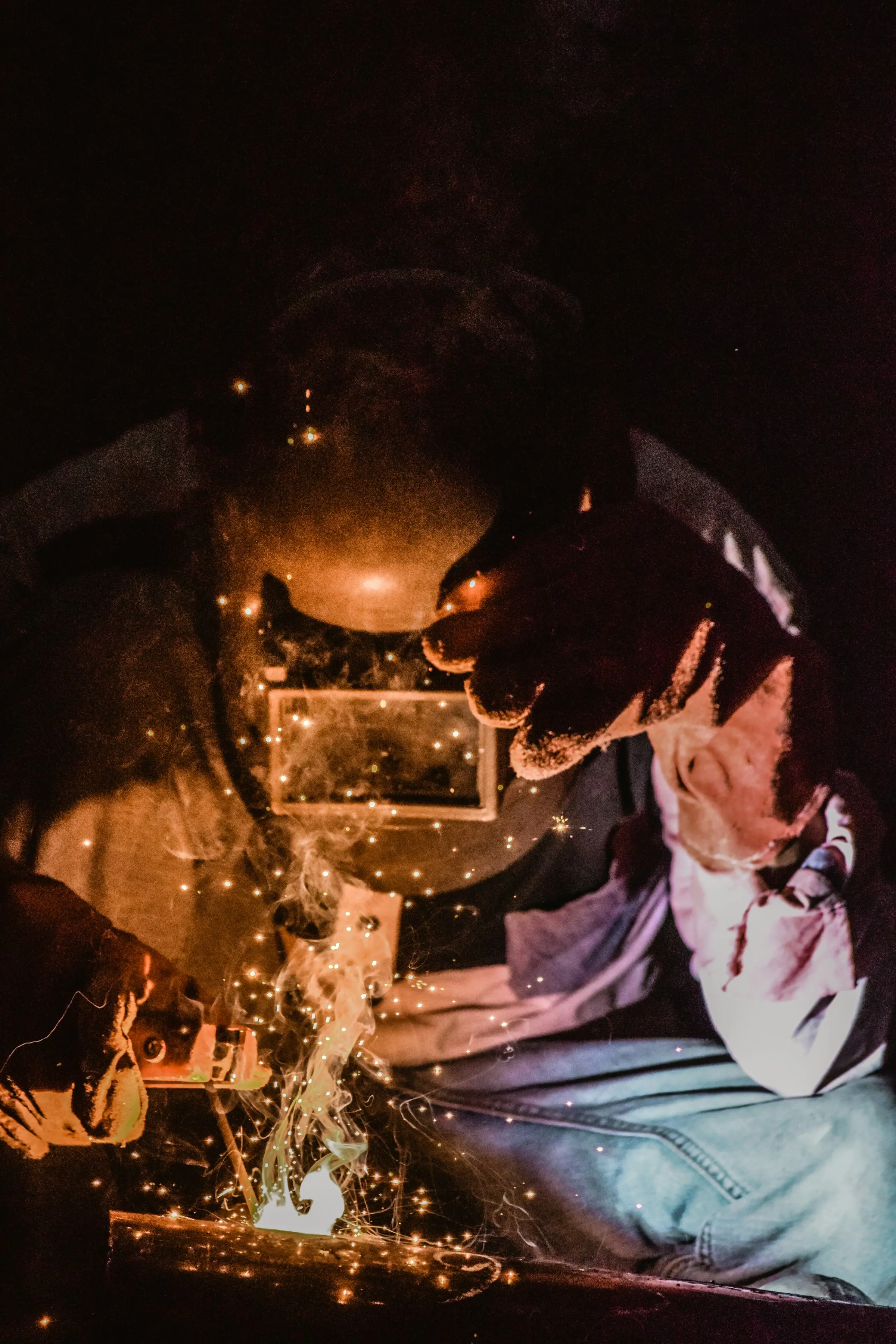 Welder at work with sparks
